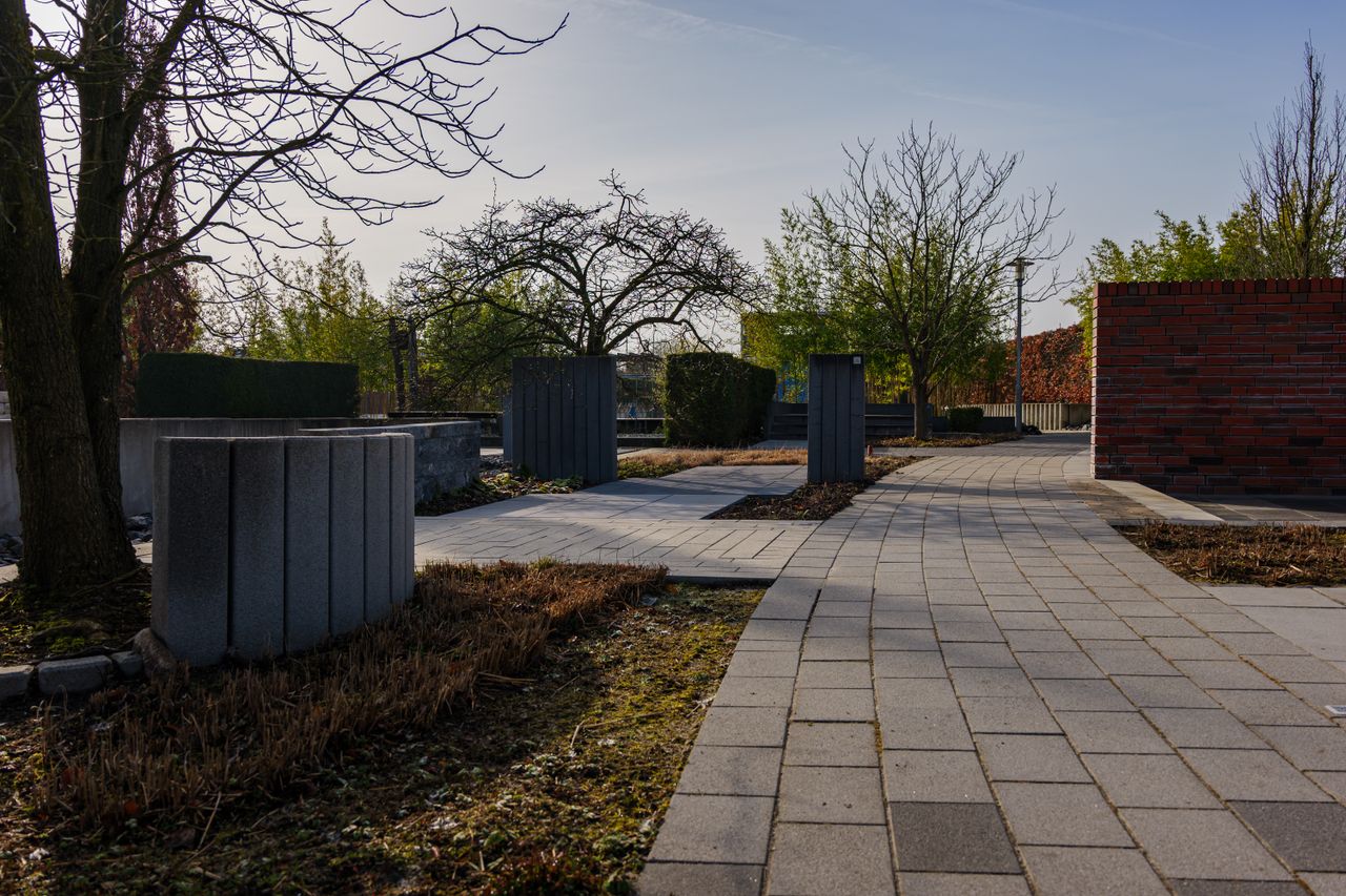 services-02 Peaceful cemetery walkway with trees and modern design in Coesfeld, Germany.